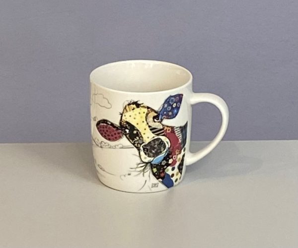 Classic white mug with a cute cow chewing the cud with a colourful collage decoration. Quirky Connie Cow Bug Art mug