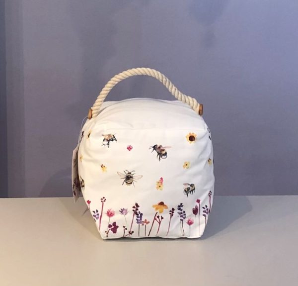 classic white weighted doorstop with a wild flower garden and busy bees, Cube shaped doorstop with a rustic rope handle