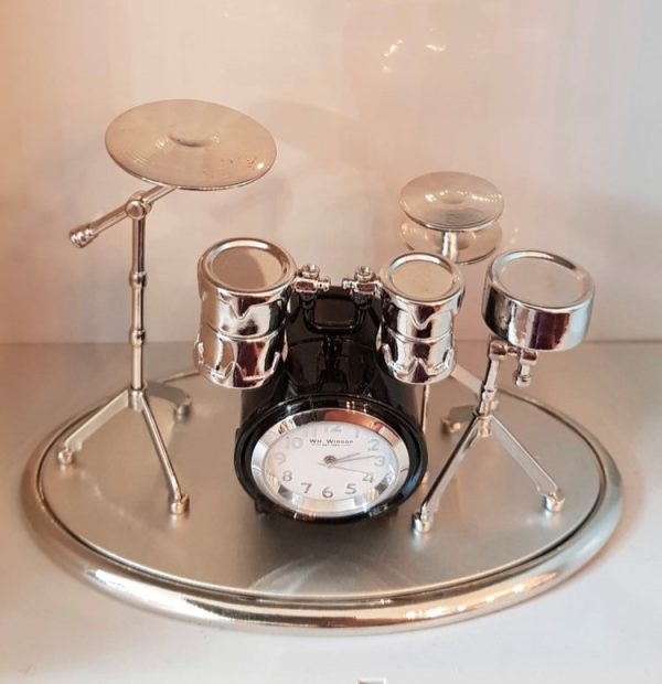Metal drum set ornament with a miniature clock set into the bass drum