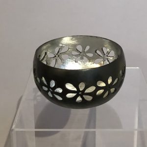 Recycled coconut bowl with hand carved flower design and silver interior