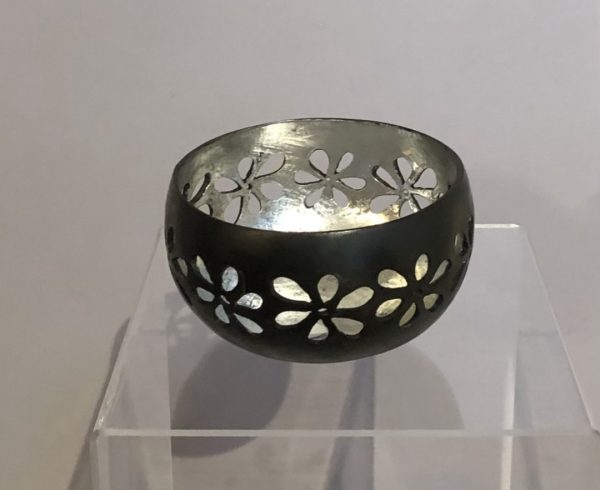 Recycled coconut bowl with hand carved flower design and silver interior