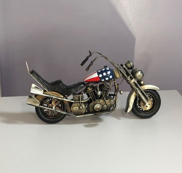 Highly detailed replica of a vintage Harley Davidson motorbike.