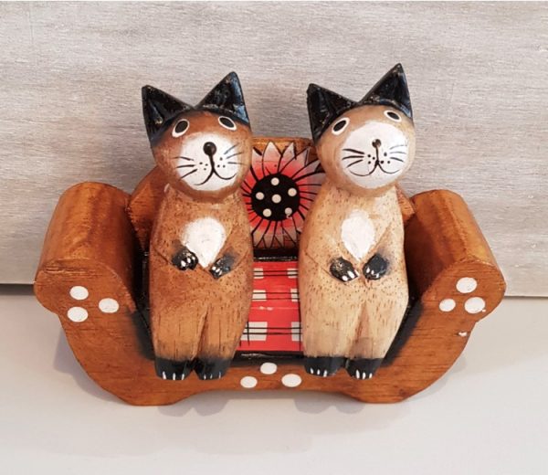 wo cats sitting on a sofa wooden ornament
