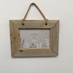 rustic driftwood wall mounted photo frame with a rope hanger.