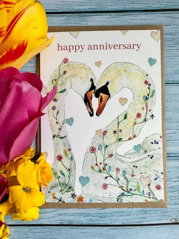 Happy Anniversary eco card shwoing a pair of swans with floral embellishments. An original art print from the wagtercolour Hopelessly devoted swans by Jen Winnett