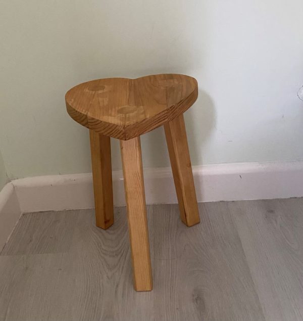 heart shaped wooden stool hand crafted in the Cotswolds and finished with a light oak wood stain