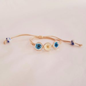 Cord bracelet with real blue and white flower charms