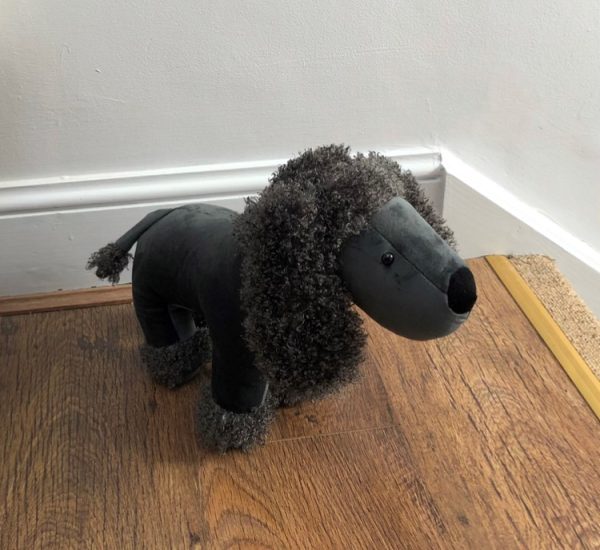 grey fluffy poodle doorstop