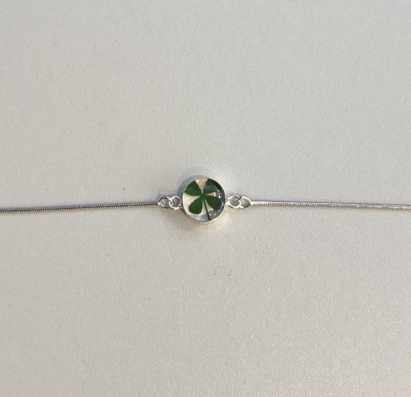 silver bracelet with a real four leaf clover