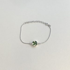 lucky four leaf clover charm on a silver bracelet