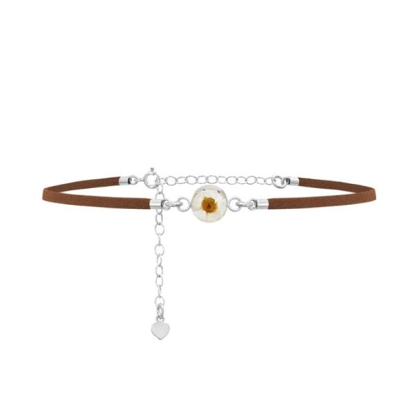 faux suede choker necklace with a silver charm containing a real daisy encased in resin