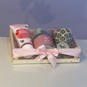 Mother's Day pampering gift. Wooden storage crate filled with scented candle, shower gel, soap roses, soap cake and mini plant pot