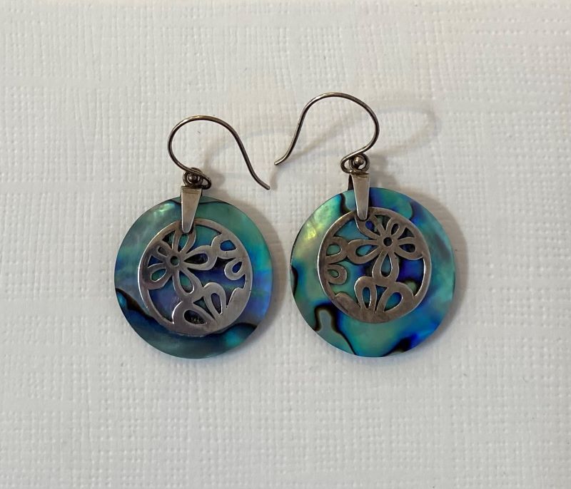 Beautiful earrings featuring a colourful circle of abalone overlaid with flowers handcrafted from sterling silver