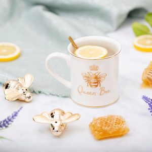 Classic white porcelain mug from Sass & Belle with gold trim and gold bee and crown and gold text saying Queen Bee