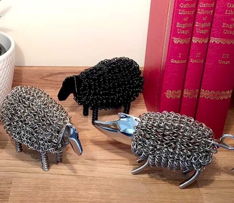 Black sheep wiggle animal. A quirky metal sheep sculpture made with coiled nickle plated wire with a black finish