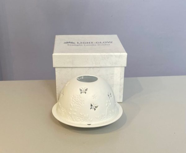 Dome tea light holder with a butterfly and flower design etched into its dome to create a stunning effect when it is lit from within