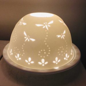 Dome tea light holder with a dragonfly design etched into its dome to create a stunning effect when it is lit from within