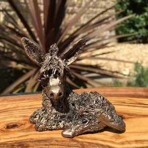 Dusty donkey Frith Sculpture. Super cute statue of a baby donkey sitting and resting. Hand finished cold cast bronze ornament