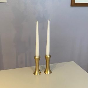 Eye catching taper candle holder crafted from sand cast fine brass which is spun and then given a clear lacquer to create a silvery brass effect