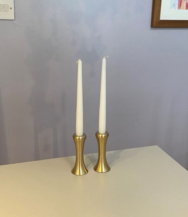 Eye catching taper candle holder crafted from sand cast fine brass which is spun and then given a clear lacquer to create a silvery brass effect