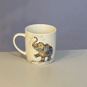 Classic white mug with a cute marching elephant with a colourful collage decoration. Quirky Eddie Elephant Bug Art mug
