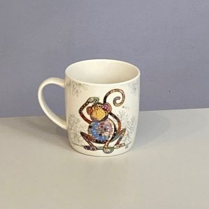 Classic white mug with a cute monkey with a colourful collage decoration. Quirky Monty monkey Bug Art mug