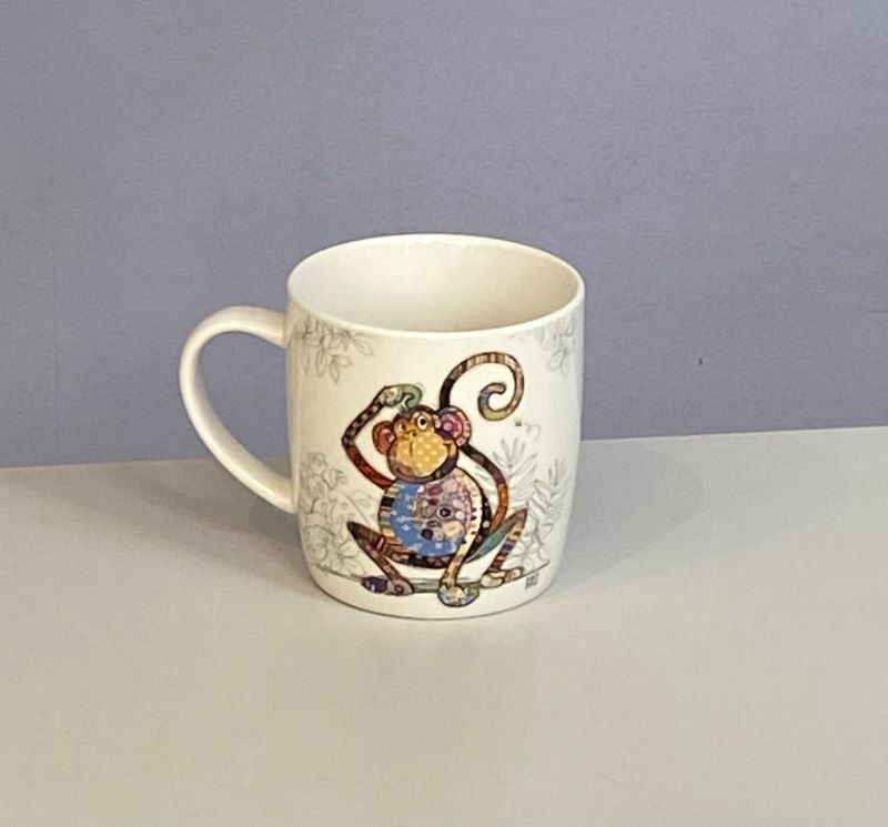 Classic white mug with a cute monkey with a colourful collage decoration. Quirky Monty monkey Bug Art mug