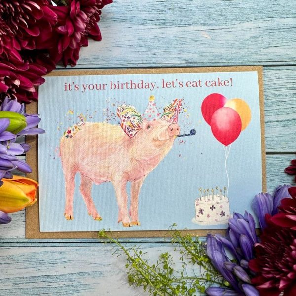Birthday pig colourful card designed by Jen Winnett showing a pig with floral decorations, balloons and birthday cake.