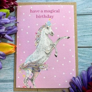 Hve a magical birthday eco friendly card with a pink background and unicorn with decorative text saying Have a magical birthday