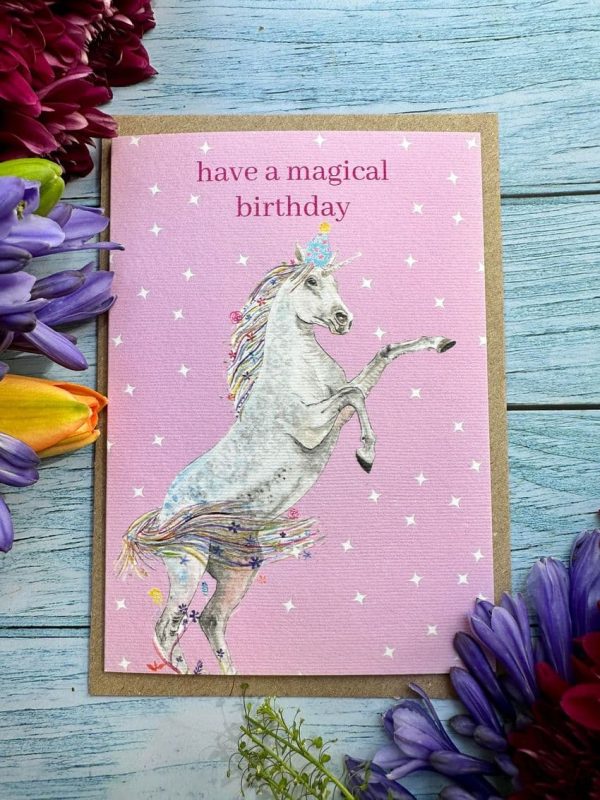 Hve a magical birthday eco friendly card with a pink background and unicorn with decorative text saying Have a magical birthday