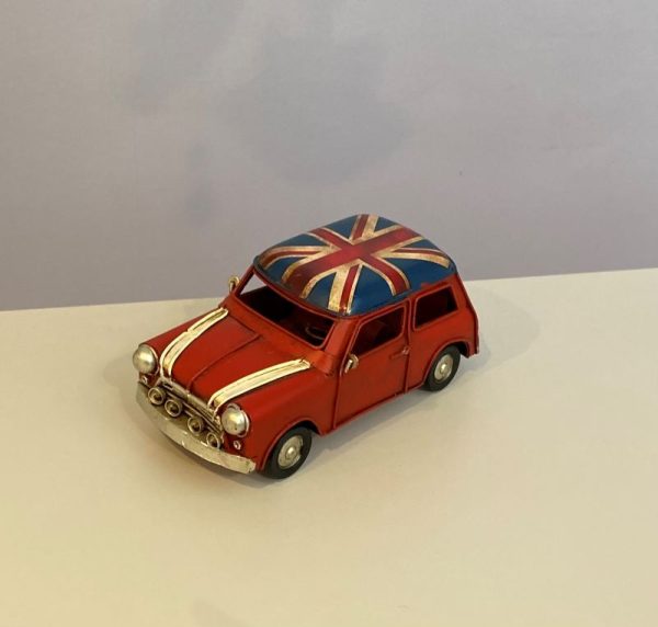 Metal model of a vintage mini car in classic red with white trim and a union jack roof