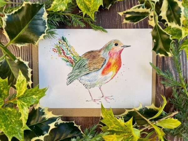 Eco friendly Christmas card showing a robin with colourful Christmas themed embellishments
