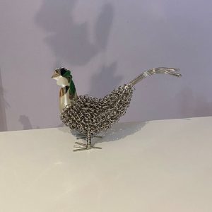 Quirky metal chicken ornament made from wire twisted over a metal frame